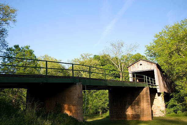 Modern bridge leading to a covered wooden bridge