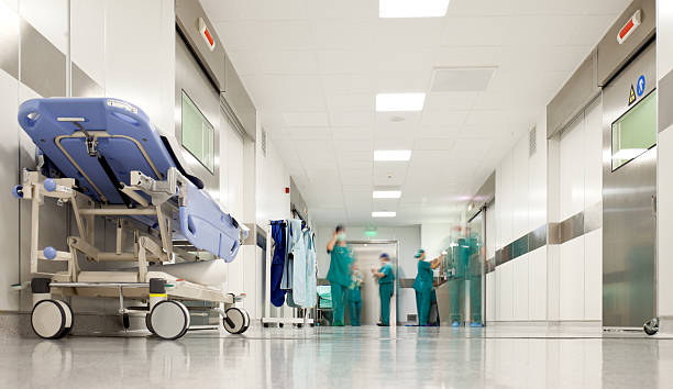 Blurred figures of people with medical uniforms in hospital corridor