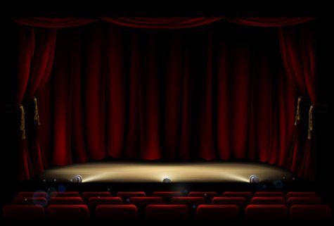 An illustration of a theatre or theater stage and seating with footlights and red curtains